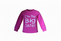 pink long sleeve sweatshirt with large white writing "im the big sister" on a white background