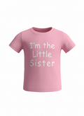 Pink t-shirt with 'I'm the Little Sister' text on a white background