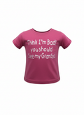 Pink t-shirt with white text on a white background